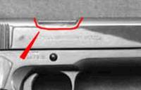 The red outlines the bottom of the standard ejection port on an original 1911A1.
